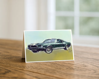 7x5 landscape greeting card displayed on a wooden table featuring an artistic illustration of a 1968 Ford Mustang GT350 classic muscle car against a soft green and yellow background, fine art by Will Davis Studios