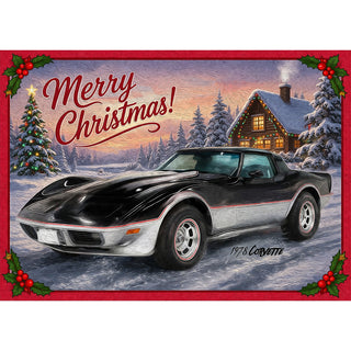 1978 Corvette Christmas greeting card showing the classic black and silver C3 sports car in fresh snow beside a log cabin with colored holiday lights and a decorated tree, framed with holly and Merry Christmas lettering. 5x7 card.