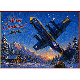 Blue Angels Fat Albert C-130 Christmas card on a wooden table surrounded by pine garland, ornaments, and holiday lights.