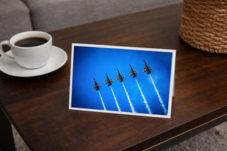 Greeting card with airplane display on a table next to a cup of coffee