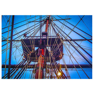 Close-up of a ship's rigging against a blue sky