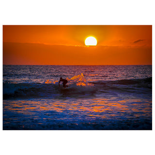 Surfer riding a wave at sunset with an orange sky. Fine Art Greeting Card by Will Davis Studios Photo by Matt Punches