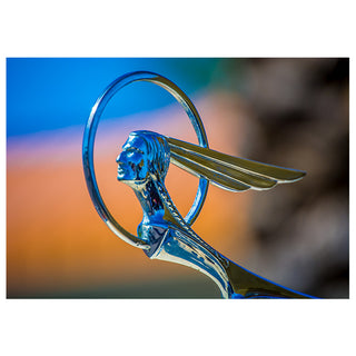 Close-up of a vintage Pontiac hood ornament with a blurred background Photo by Matt Punches