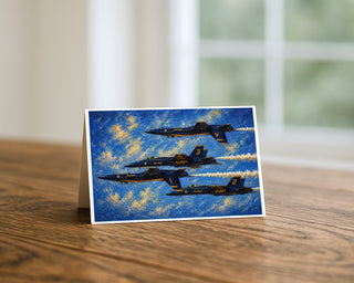 Blue Angels side profile 5x7 greeting card from Will Davis Studios displayed standing on a wooden table near a bright window — four US Navy F/A-18 Hornets in side view with contrails against a painterly blue sky, naval aviation fine art card