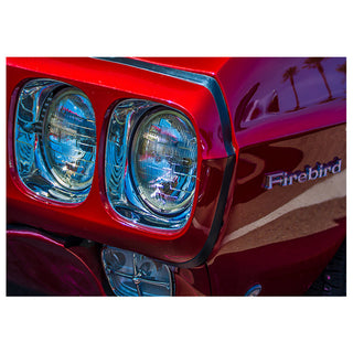 Fine art close-up photograph of a candy apple red Pontiac Firebird with chrome dual headlights and iconic nameplate badge, printed as a 5x7 greeting card by Will Davis Studios.