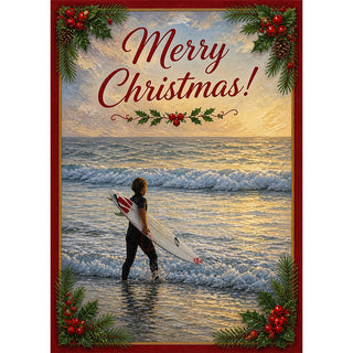 Surfer Christmas greeting card showing a lone surfer standing in the shallows at golden hour with board under arm, framed in crimson with holly, pine sprigs, and berries, with Merry Christmas lettering across a glowing sunset sky. 5x7 card.