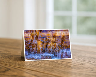 Greeting card with a watercolor design of a waterfall on a wooden surface. Will Davis Studios