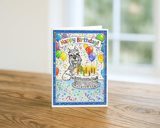 Birthday card with a dog and cake illustration on a wooden surface by Will Davis Studios
