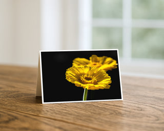 Greeting card with a yellow flower design on a wooden surface by Will Davis Studios