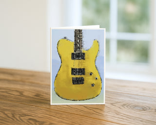 Will Davis Studios Greeting card with a yellow electric guitar design on a wooden surface.