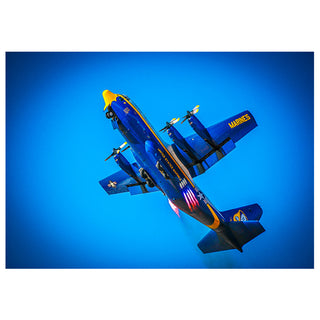 Blue and yellow airplane with 'Marines' branding against a blue background Blue Angels