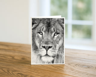 Greeting card with a lion's face on a wooden surface by Will Davis Studios