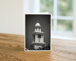 Greeting card with a black and white photo of a clock tower on a wooden surface. Will Davis Studios