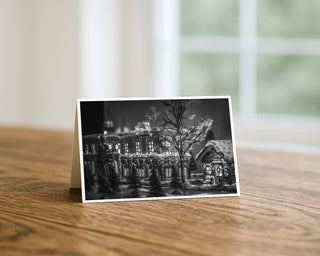 Black and white photo of a building on a wooden surface with a blurred background Christmas Greeting Card by Will Davis Studios