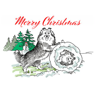 Fine art greeting card featuring a charming classic pen and ink illustration of two Shetland Sheepdogs in a hilarious Christmas snow scene, one Sheltie standing triumphantly with paw resting on an enormous snowball while a second Sheltie peers out from inside the snowball with a dazed expression, set against snow-dusted pine trees and a cheerful snowman, with Merry Christmas in elegant red script above, 5x7 greeting card with envelope by Will Davis Studios.
