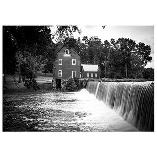 Black and white photo of a mill with a waterfall in front