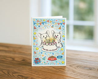 Greeting card with two dogs celebrating a birthday on a wooden surface Welsh Corgi Birthday Will Davis Studios