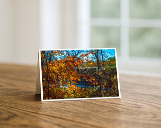 Greeting card with autumn landscape on a wooden surface by Will Davis Studios