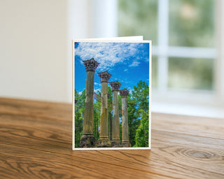 Greeting card with classical columns design on a wooden surface