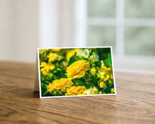 Floral card with yellow flowers on a wooden surface by Will Davis Studios