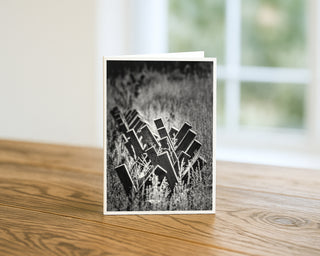 Black and white wooden fence in Montana greeting card displayed on a wooden table, rustic western fine art photography 5x7 card by Will Davis Studios